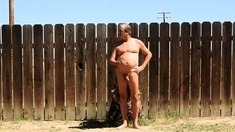 A daddy parading around naked in his backyard.